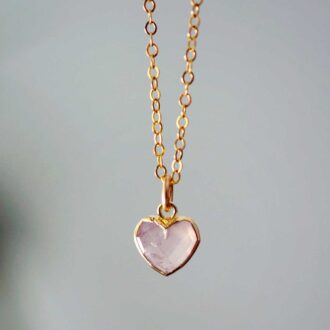 Rose quartz heart pendant set in gold on a delicate chain.