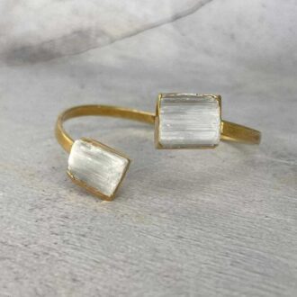 Luminous 24k gold adjustable cuff bracelet set with two raw selenite crystals, symbolizing clarity and energetic cleansing.