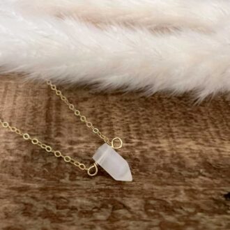 Delicate gold-filled necklace featuring a natural selenite crystal point pendant, symbolizing peace, clarity, and spiritual connection.