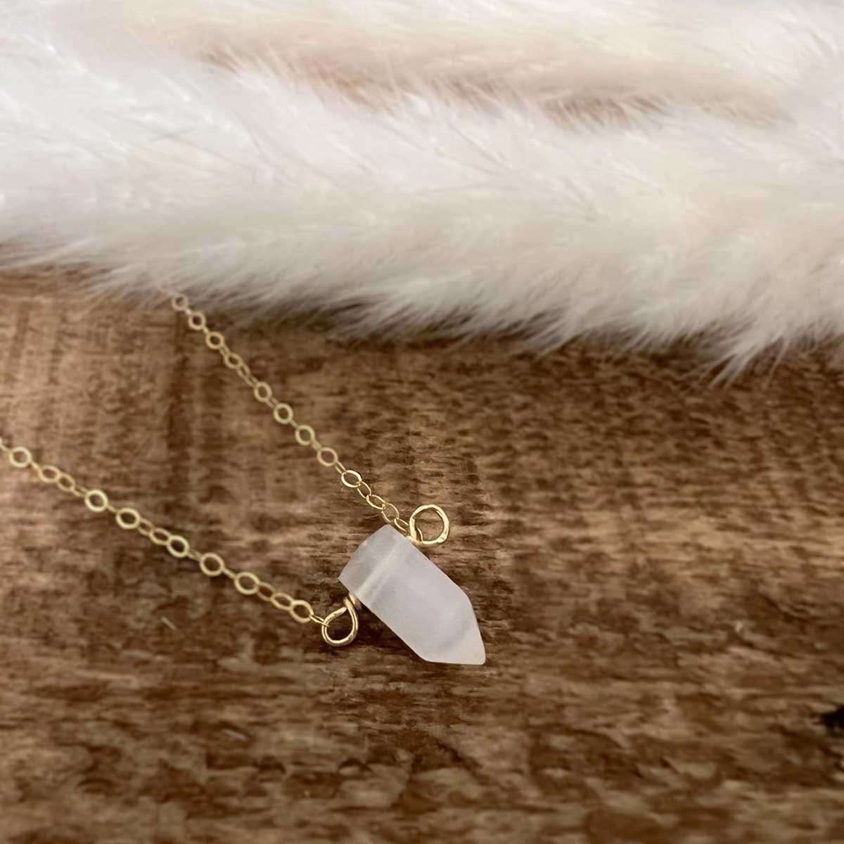 Delicate gold-filled necklace featuring a natural selenite crystal point pendant, symbolizing peace, clarity, and spiritual connection.