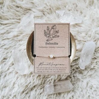 Selenite crystal wish bracelet with hemp cord, gold bead accents, and eco-friendly packaging card designed for purification and serenity.