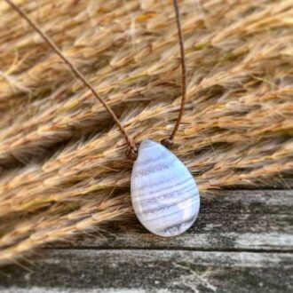 Smooth blue lace agate teardrop necklace on a light brown cord.