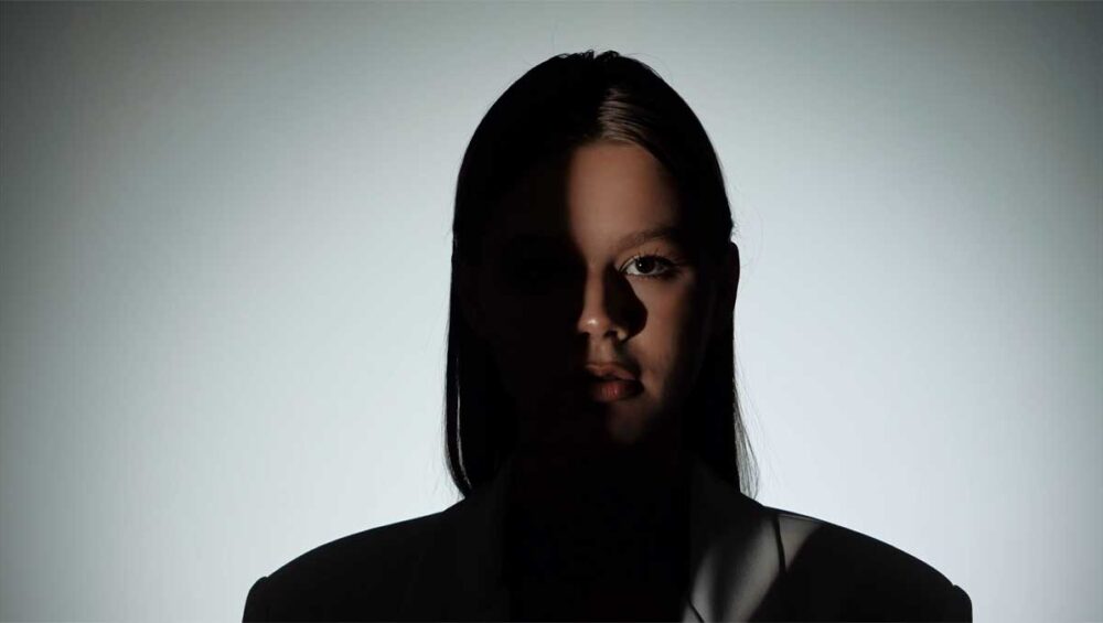 woman’s face half in shadow symbolizing gaslighting and trust erosion