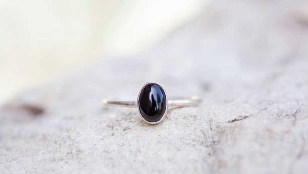 black tourmaline birthstone ring set on natural stone