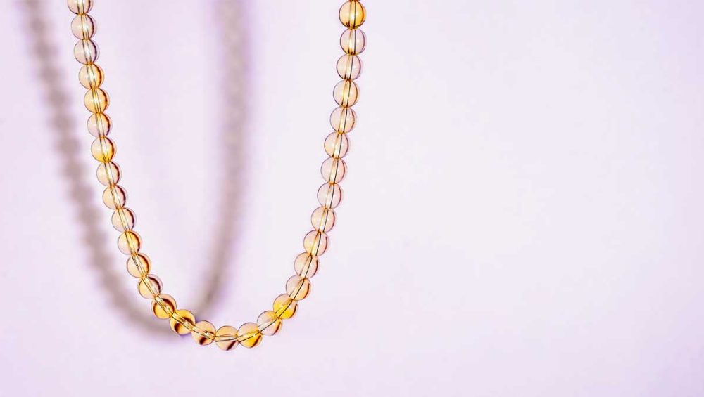 Citrine bead necklace on a soft light background