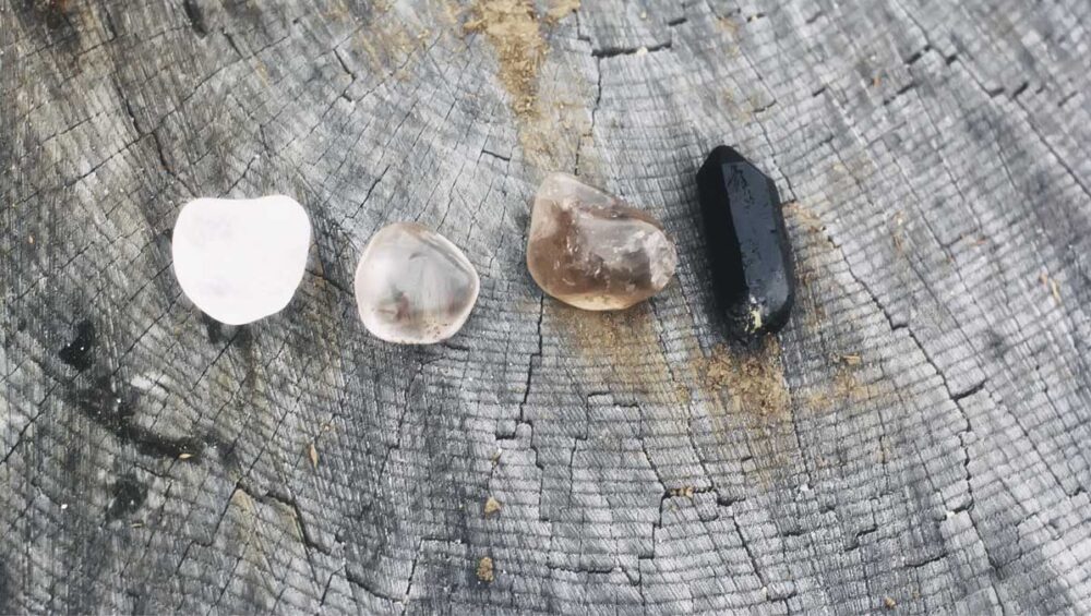 gentle cleansing crystals resting on a tree stump for empaths