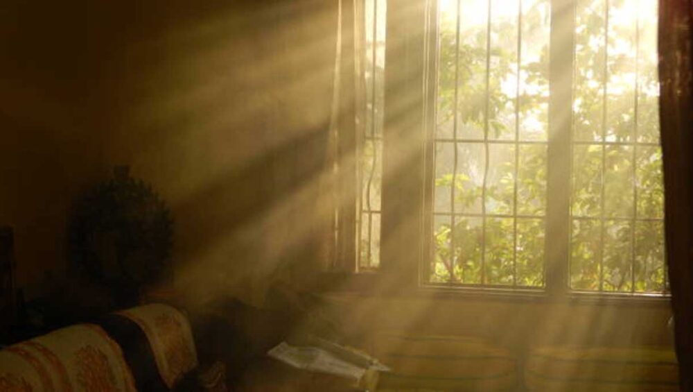 Sunlight streaming through a window into a quiet room