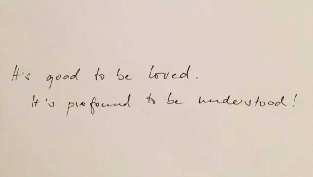 Handwritten quote on a blank background that reads, “It’s good to be loved. It’s profound to be understood!”