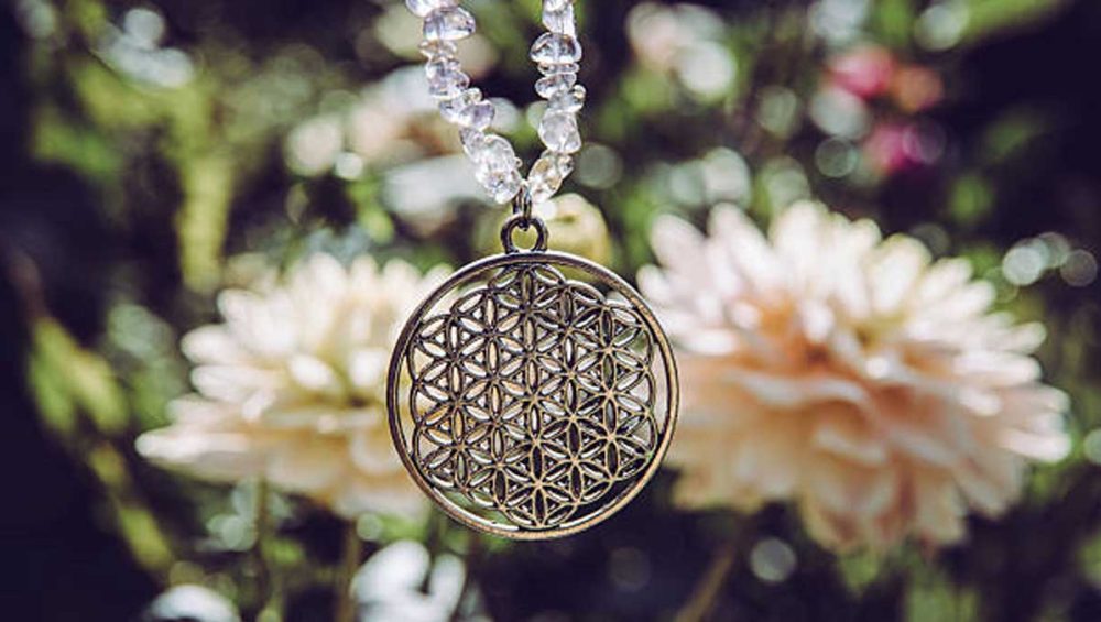 flower of life pendant necklace hanging outdoors in soft natural light