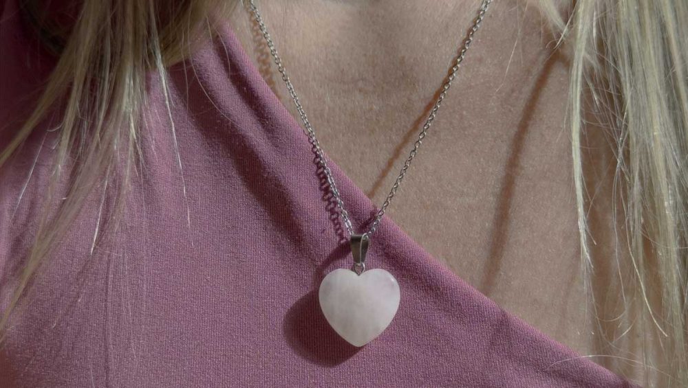 rose quartz heart necklace worn on a chain for valentines day jewelry gift