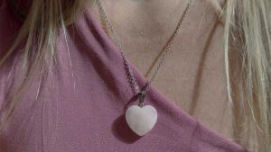 rose quartz heart necklace worn on a chain for valentines day jewelry gift