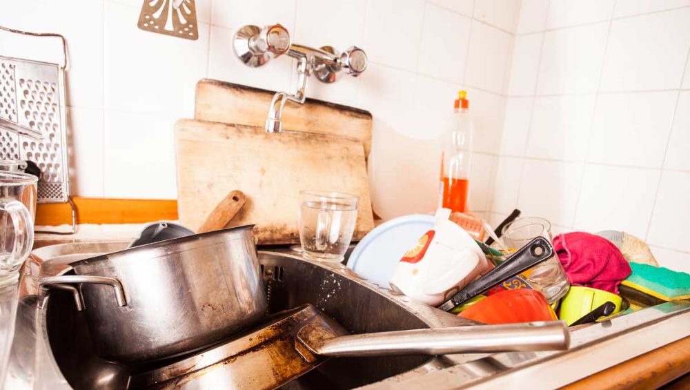 kitchen sink full of dirty dishes representing the buildup of unresolved issues in arguments