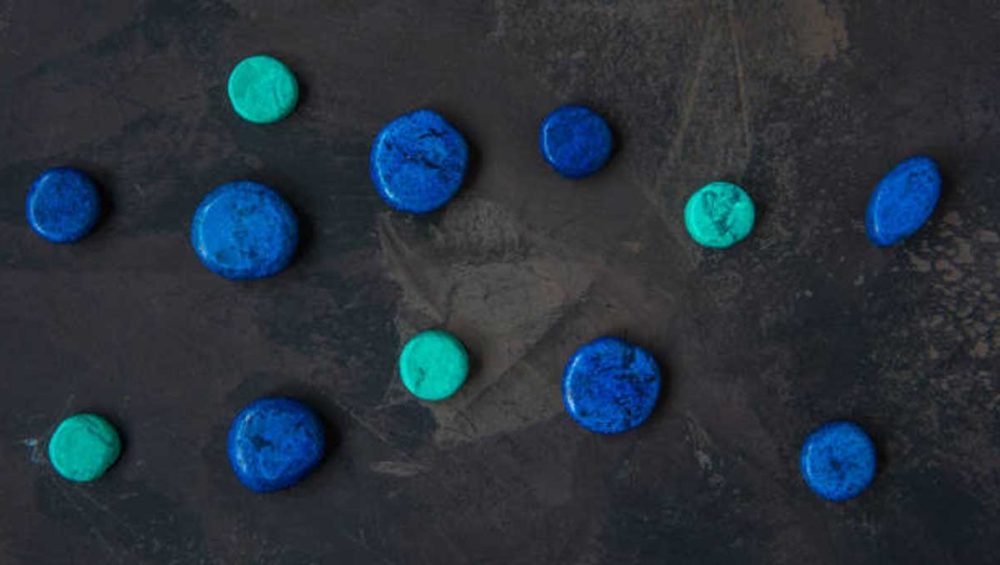 turquoise and lapis lazuli stones arranged on a dark textured surface