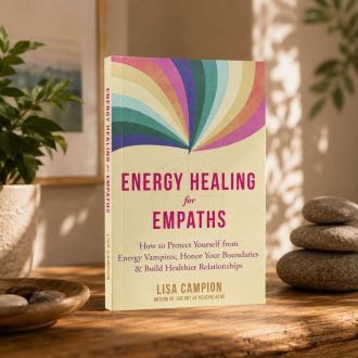 Energy Healing for Empaths book displayed on a wooden table in a calming wellness-inspired setting with natural light and plants