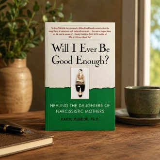 Book titled Will I Ever Be Good Enough? Healing the Daughters of Narcissistic Mothers displayed upright on a wooden table in a warmly lit interior setting.